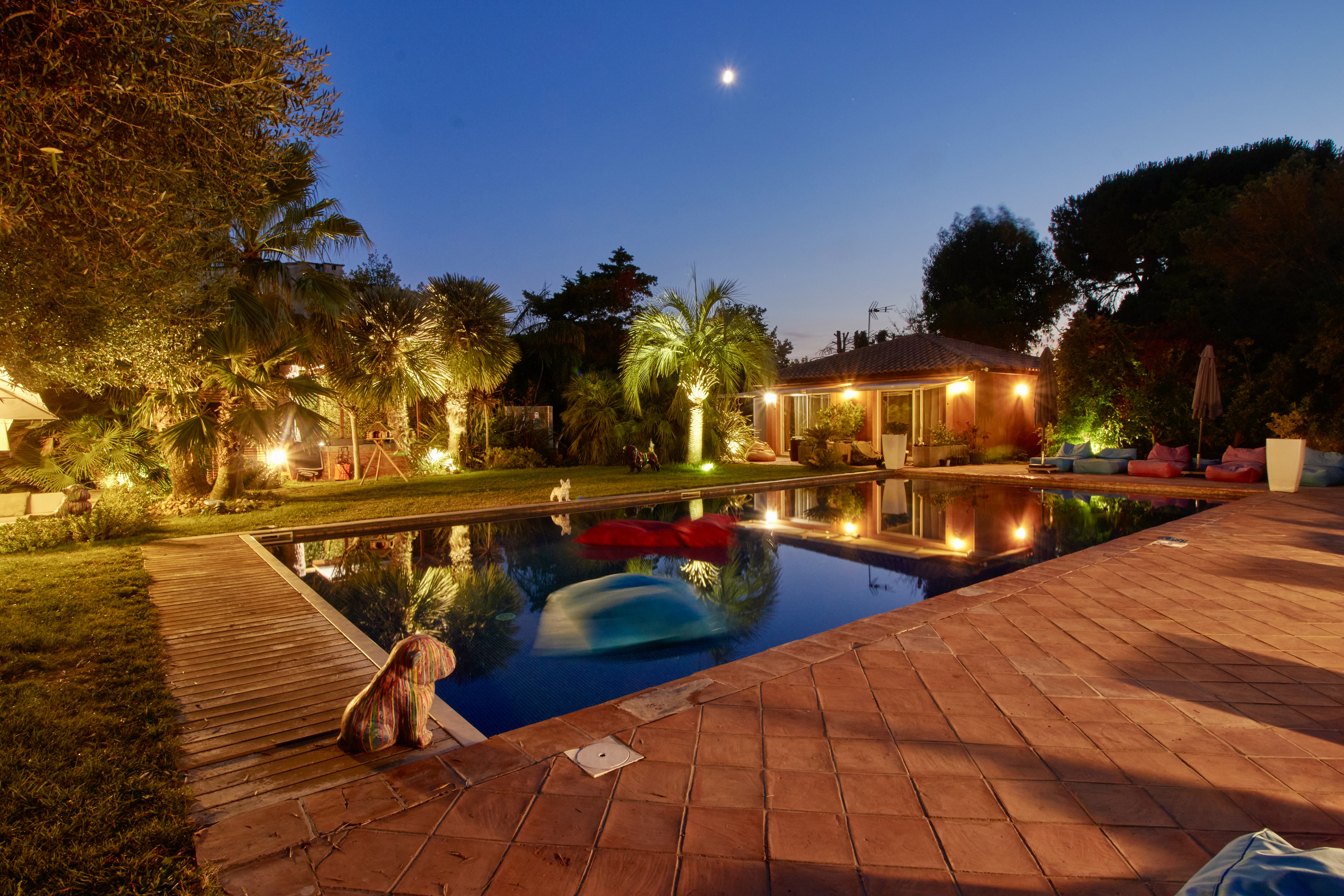 Piscine de nuit avec lune et illuminations